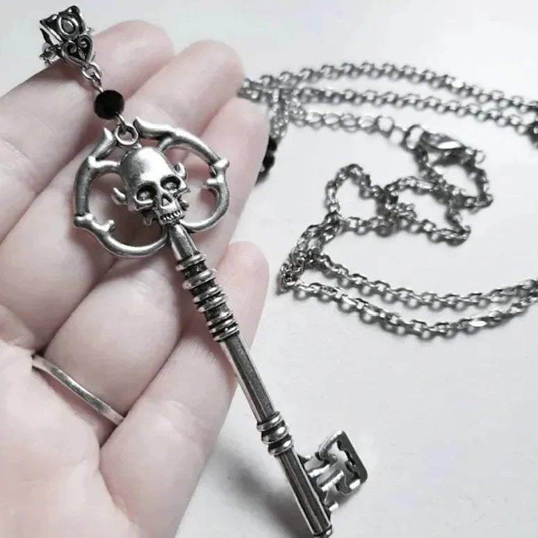 Necklace with key and skull pendant
