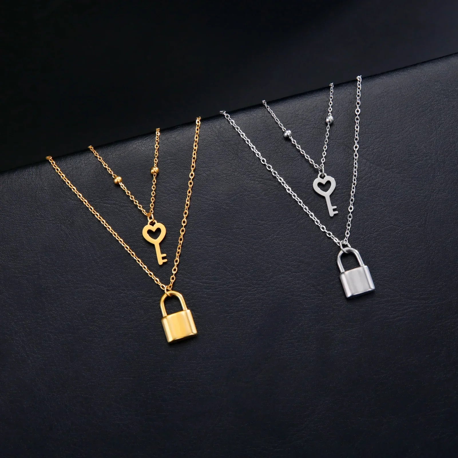 Double necklace with gold key and lock pendant