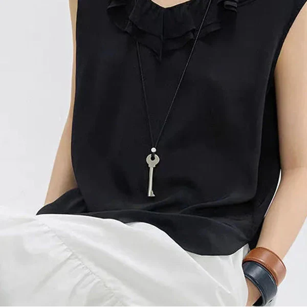 Long cord necklace with matte silver key pendant