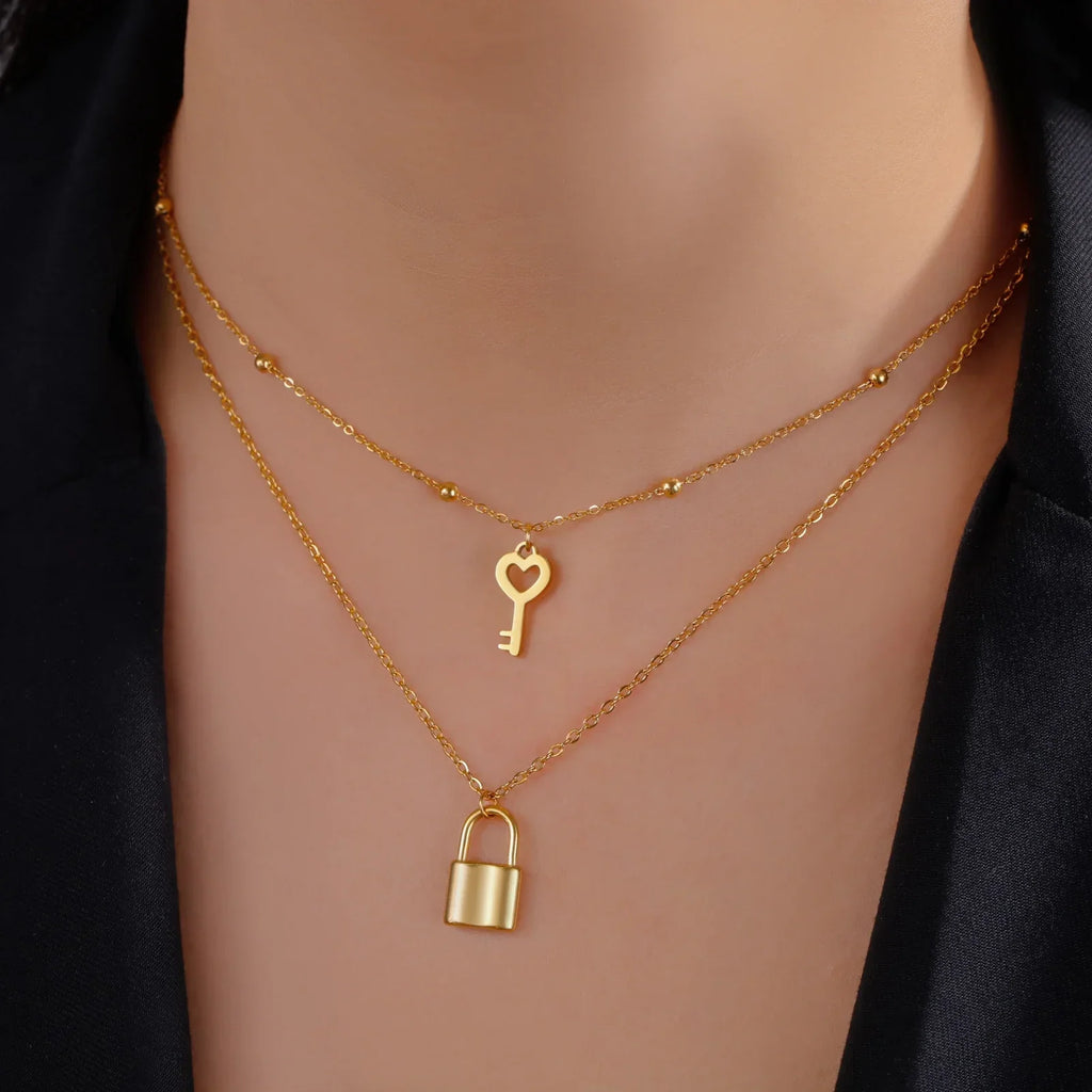 Double necklace with gold key and lock pendant