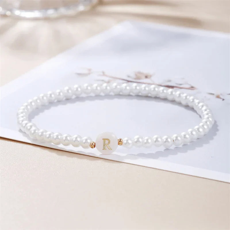 White bracelet initial R