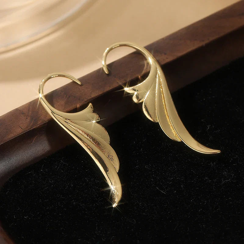 Gold women's angel wing dangle earrings