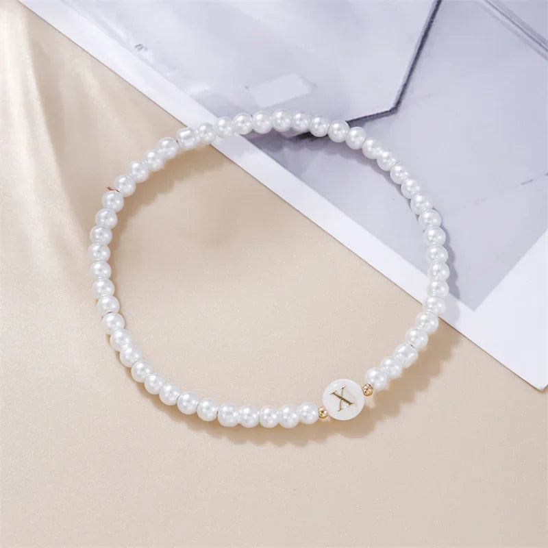 White bracelet initial X