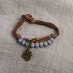 String Bracelet with Four-Leaf Clover and Blue Beads