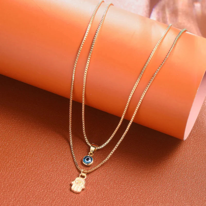 Double Necklace with Turkish Blue Eye and Fatima's Hand Pendant gold