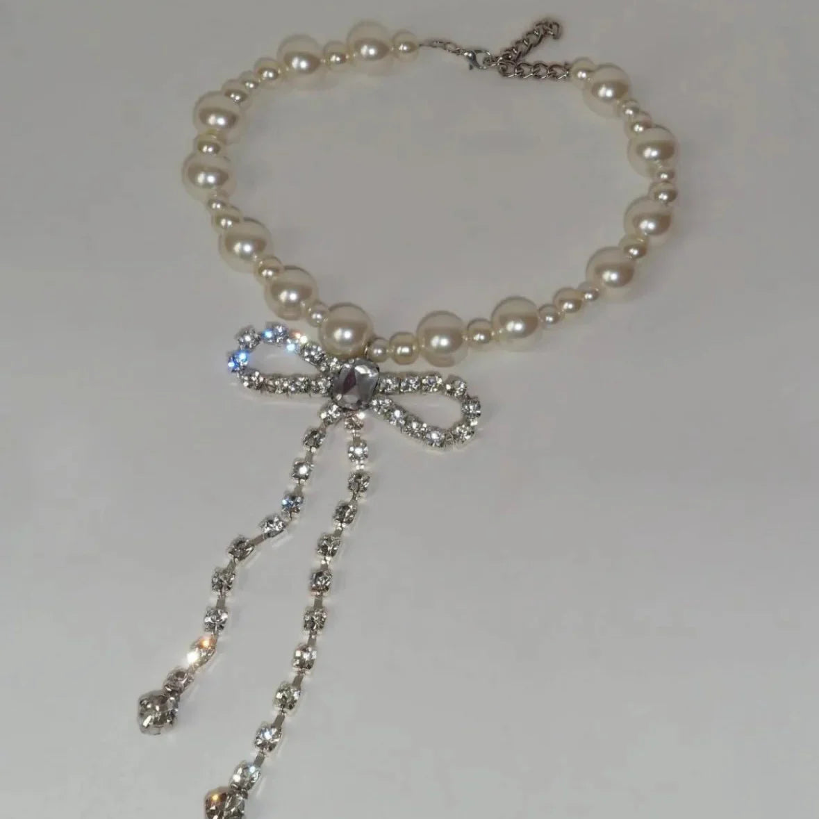 Choker necklace with rhinestone bow pendant