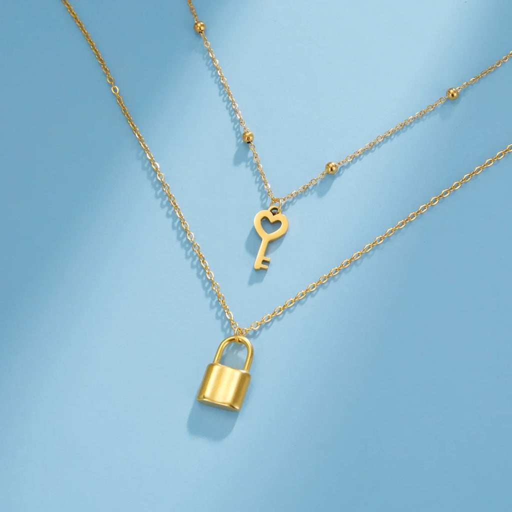 Double necklace with gold key and lock pendant