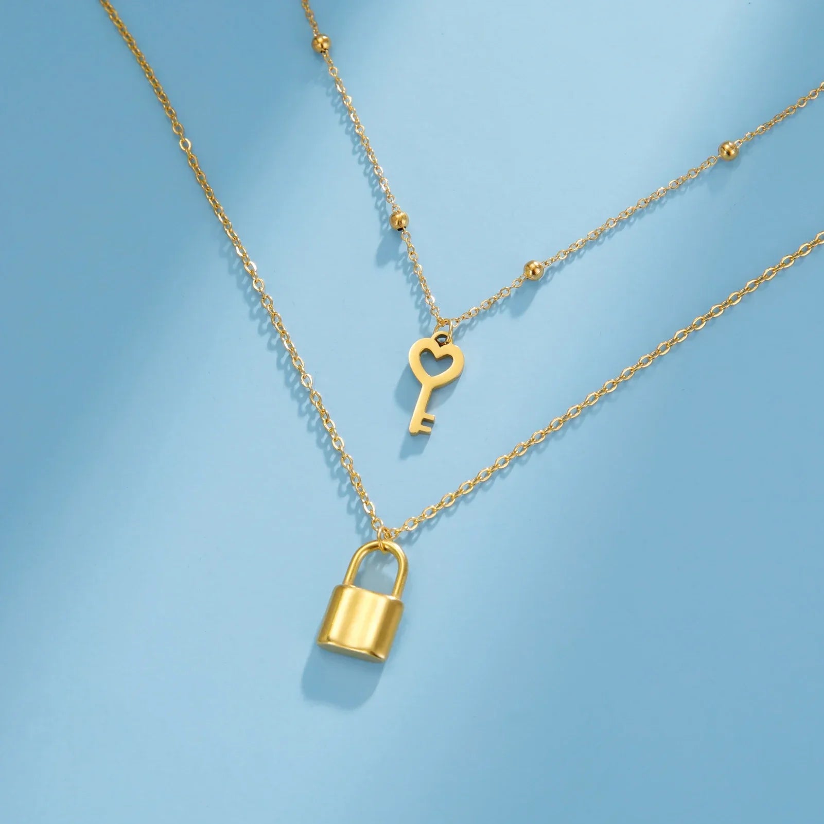 Double necklace with gold key and lock pendant