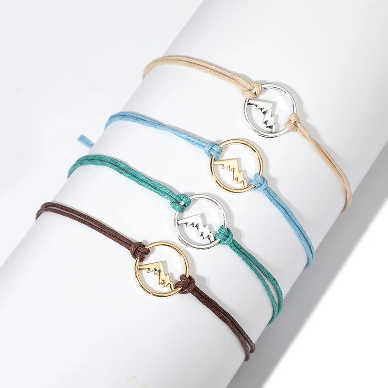 Set of 4 Rope Bracelets with Round Mountain Pendant